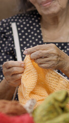 Elderly woman knitting for protect dementia and memory loss.