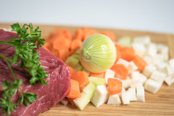 Raw beef meat on a cutting board with fresh vegetable - 764619689