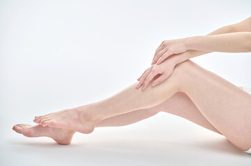 Isolated on the legs, hands and white background of a young Asian woman on a diet.