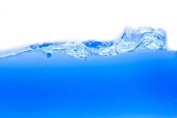 Drink clean blue water in a glass and the bubbles look like splashes and waves.