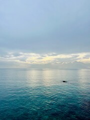 Fantastic seascape background, bright cloudy sky reflection on the blue sea surface, blue sea horizon background