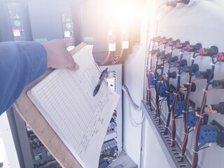 The Electric Enginering checklist and maintenance electric panel in power house.preventive maintenance schedule for electrical panel boards.with shiny light.
