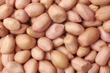 close-up macro view of peanuts, aka groundnuts, most popular nuts with skin, enjoyed for their...
