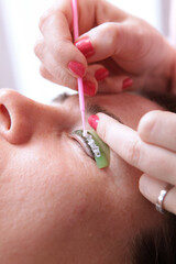 Lamination of eyelashes. Eyelash care procedures in a beauty salon. The concept of beauty. Close-up.