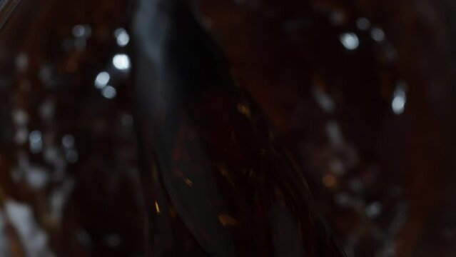 Top View, Pouring Carbonated Cola into a Glass, Macro Slow Motion.