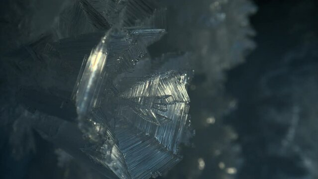 Close up ice crystal, sharp ice snowflakes on stalactites inside cave 