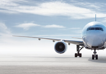 Front view of wide body passenger aircraft isolated on bright background with sky