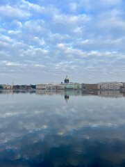 Fototapeta premium Amazing bright cloudy sky and buildings reflection at the city river 