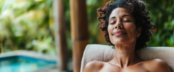 Foto op Aluminium Lifestyle portrait of beautiful black woman relaxing by spa pool at luxury resort  © Elena