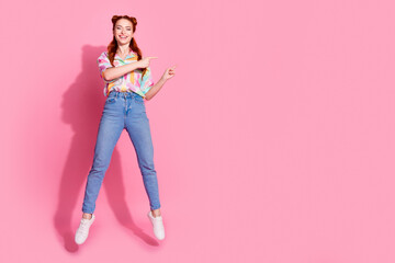 Full size photo of adorable girl dressed colorful blouse flying indicating at discount empty space...