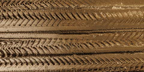 view from above on texture of wet muddy road from above on surface of wet gravel road with tractor tire tracks in countryside - 764647246