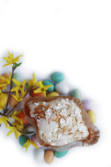 Sweet Easter cake named Colomba Pasquale (Easter dove) with chocolate eggs on white background. Italian traditional pastry 
