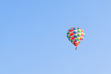 Hot air balloons landing in a mountain flight over field and forest,colorful Hot air balloons flying over the valley with blue sky,Tourism concept.