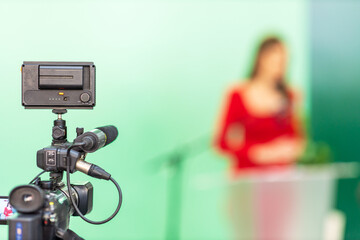 Filming media event or press conference with a video or television camera. Public speaking concept with copy space.