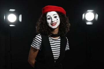 Young woman in mime costume performing on stage