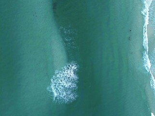 Aerial view of turquoise sea with waves