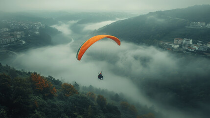 Paraglider Soaring Over Clouds and Mountain