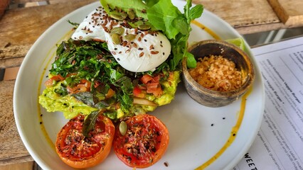 breakfast with vegetables and a poached egg.