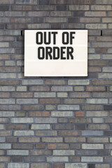 Fototapeta na wymiar Out of Order message in lightbox on brick wall