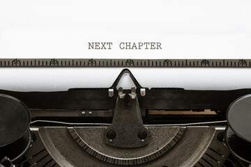 Next Chapter headline written on vintage type writer from 1920s