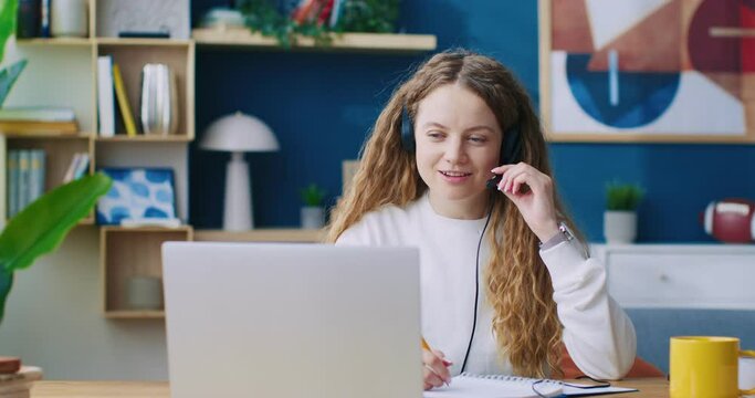 Customer service consultant, helping desk and advice with tech support and headset. Call-center and phone call, communication, talking with CRM, contact costumers and laptop at home office.