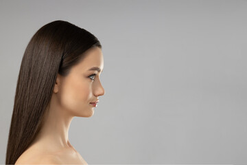 Attractive young girl on a gray background. Botox concept
