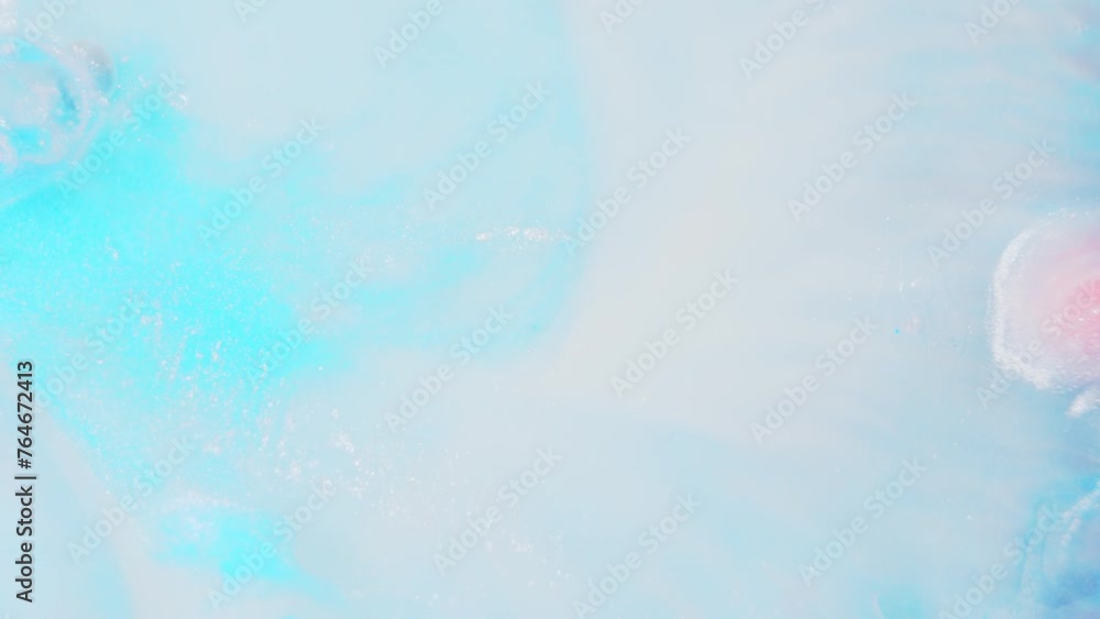 Poster vibrant blue and pink ink diffusing in water, creating an abstract art effect