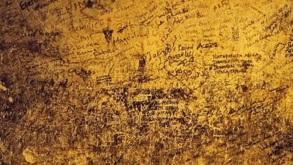 Graffiti-Scrawled Wall A Tangle Of Names And Messages On Textured Surface. The Wide-Angle Shot Captures The Raw Expression Of Urban Art And Vandalism