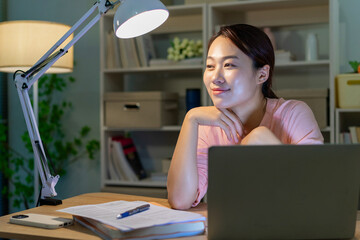 Young Asian woman working late at midnight