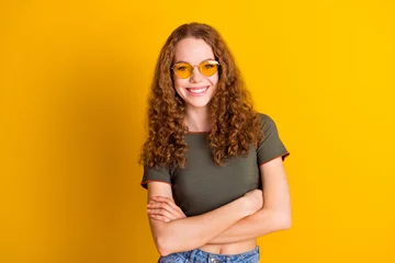 Deurstickers Photo of adorable gorgeous girl dressed nice outfit standing crossed arms isolated on yellow color background © deagreez