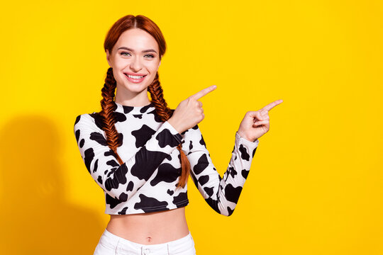 Fototapeta Photo of excited cheerful lady dressed cowskin top showing two fingers empty space isolated yellow color background