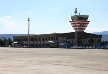 Small airport control tower and runway field. - obrazy, fototapety, plakaty