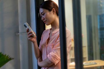 Photo of young Asian woman thinking at home