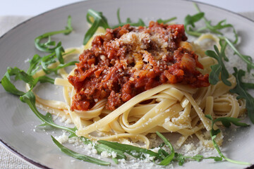 Traditional Bolognese Linguine with Shaved Parmesan and Fresh Arugula