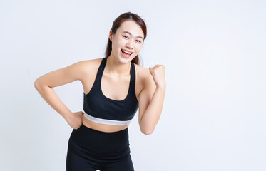 Fototapeta na wymiar Young Asian woman wearing sportswear on white background