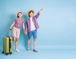 Young Asian couple on blue background