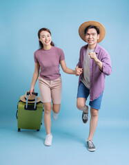 Young Asian couple on blue background