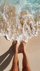 A woman's feet are in the ocean water. The water is the shore of the beach
