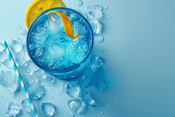 Blue curacao coctail, exotic cold shot glass cocktail with yellow lemon slice, ice cubes, on soft light mint color background, top view