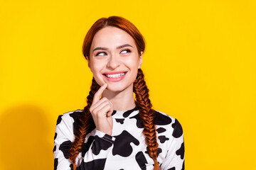 Photo of excited dreamy lady dressed cowskin top finger chin looking empty space isolated yellow...