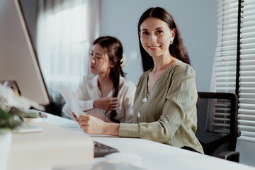Female apprentice learning business from caucasian businesswoman in office. Professional manager...