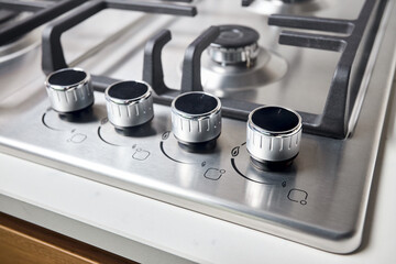Hob cooker stove oven made of stainless steel with control knobs selective focus close up over out...