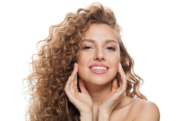 Joyful young woman with natural make-up, clear fresh skin and wavy hairstyle on white background