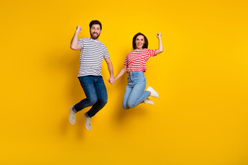 Full size photo of overjoyed ecstatic couple dressed jeans raising fists up scream win betting...