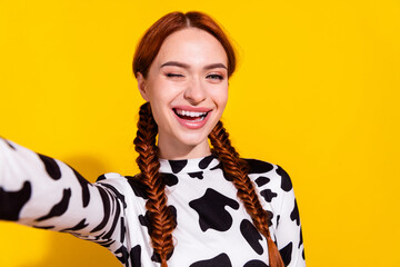 Photo of flirty funky lady dressed cowskin top winking eye tacking selfie empty space isolated yellow color background - obrazy, fototapety, plakaty