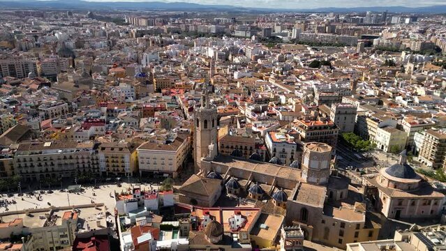 Cinematic aerial view of old town center of Valencia. View of Cathedral of Valencia and Plaza de la Reina. Drone circling above the city center. Famous travel destination. Medieval historic city.