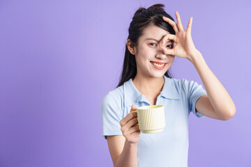 Photo of young Asian girl on purple background