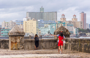 Tourist couple taking a selfie on the Malecon in Havana Cuba