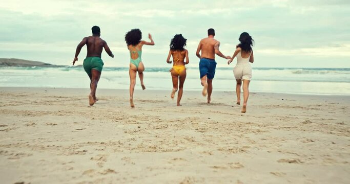 Friends, freedom and running on sand at beach for summer holiday, getaway or weekend trip in California together. Nature, travel and group of people by ocean for adventure, vacation and wellness