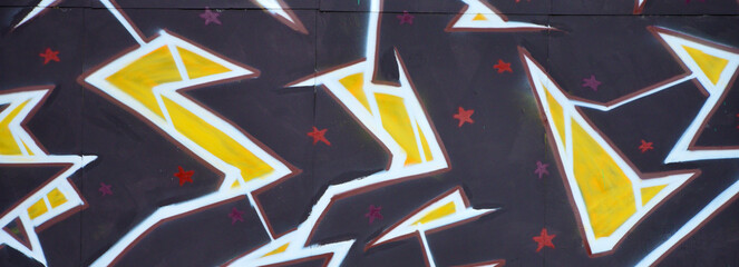 Colorful background of graffiti painting artwork with bright aerosol outlines on wall. Old school...
